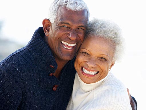 elderly couple smiling outdoors